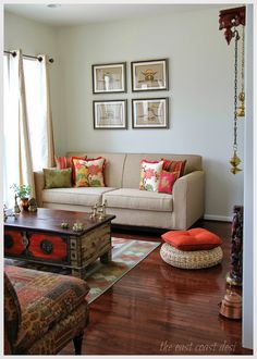 a living room filled with furniture and pictures on the wall