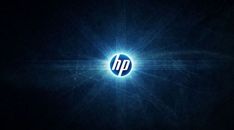 the hp logo is shown in this dark background with blue light coming from behind it