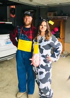 a man and woman are dressed up in animal onesuits while standing next to a car