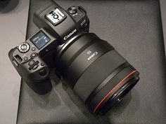 two cameras sitting on top of a table next to each other