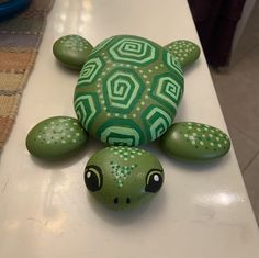 a painted turtle sitting on top of a white counter