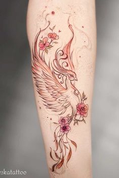 a woman's leg with tattoos and flowers on it