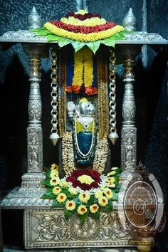 the statue is decorated with flowers and garlands