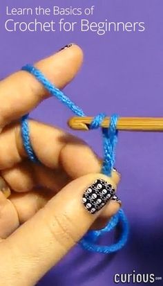 a person holding a crochet hook in their left hand and knitting the end