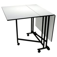 a white table with black wheels and a large rectangular table top on it's side