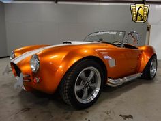 an orange sports car parked in a garage