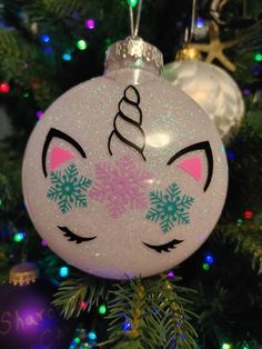 a christmas ornament with an unicorn face on it