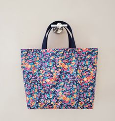 "From the world famous Liberty Fabric. Liberty LAMINATED . Medium-heavy weight.  Printed in Japan. This bag is great size for a couple of children's items and good for daycare bag. Size is 14\"W / 9.25\"H / 4\"D 100% Cotton webbing. Flat bottom shape. Fabric is Liberty of London. NO Lined inside. Please, Hand wash. All my works are carefully handmade in a beautiful cotton fabrics. Please give me 1 to 2 days for processing time prior to shipping. Made in a pet and smoke free environment.  Thanks for looking!" Large Capacity Rectangular Diaper Bag For Shopping, Square Shopping Bag With Reinforced Handles, Square Shopping Bags With Reinforced Handles, Multicolor Large Capacity Tote Lunch Bag, Large Capacity Tote Diaper Bag For Shopping, Everyday Blue Rectangular Bag, Daily Blue Rectangular Bag, Beach Tote Bag With Rolled Handles For Shopping, Shopping Beach Tote With Rolled Handles