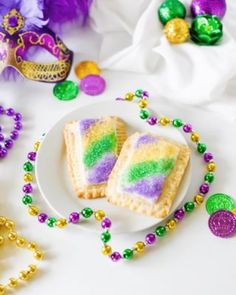 mardi gras pastries on a white plate with beads and decorations around them