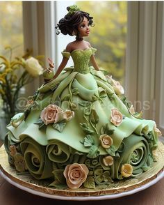 there is a cake made to look like a woman in a green dress with flowers on it