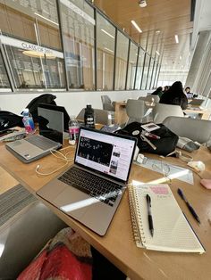 an open laptop computer sitting on top of a wooden desk