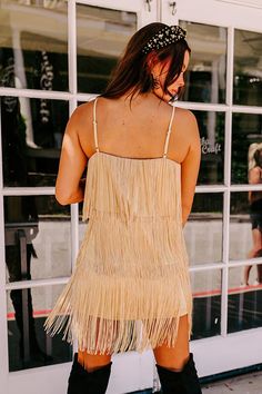 - This trendy dress is fringe at its finest! - Fully lined material with tiered fringe detail - A v-cut neckline - Adjustable spaghetti straps - A figure flattering silhouette that ends in an upper-thigh length hemline with fringe detail Measurements S : Bust 34", Hip 40", Length 24", Waist 36". M : Bust 36", Hip 42", Length 24.5", Waist 38". L : Bust 38", Hip 44", Length 25", Waist 40". Chic Gold Mini Dress For The Beach, Gold Mini Dress With Spaghetti Straps For Summer, Summer Fringe Mini Dress For Date Night, Summer Mini Dress With Fringe For Date Night, Gold Ruffled Mini Dress For Summer, Glamorous Gold Mini Dress For The Beach, Flirty Sleeveless Mini Dress With Fringe, Fitted Sleeveless Mini Dress With Fringe, Glamorous Gold Beach Mini Dress