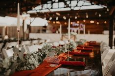 the tables are set up with candles and place settings for guests to sit down at