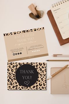 an image of a thank you card and notepad on a desk with pen, notebook, pencil and paper