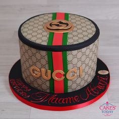 a gucci cake with the word happy birthday written on it