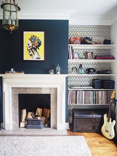 a living room filled with furniture and a fire place in front of a book shelf