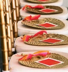 rows of white plates with red and gold designs on them are lined up against each other