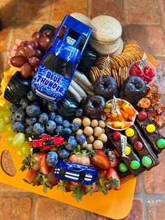 a table topped with lots of different types of fruit and snacks on top of it