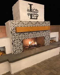 DIY Outdoor Fireplace built from cinderblock and mortar. Concrete and steel inside with firebrick. Santa Cruz design with stucco, tile, and mantel on front. Sitting wall with lights and large paver patio. Cement Outdoor Fireplace, Diy Fireplace Outside, Outdoor Wall Fireplace Ideas, Outdoor Fireplace Tile Ideas, Outdoor Wall Fireplace, Rancho Backyard, Cheap Outdoor Fireplace, Tile Outdoor Fireplace, Cinderblock Wall Makeover Backyard