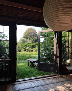 an open room with sliding glass doors leading to the outside patio and picnic table in the yard