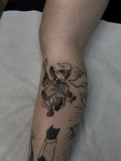 a person with a cat tattoo on their leg