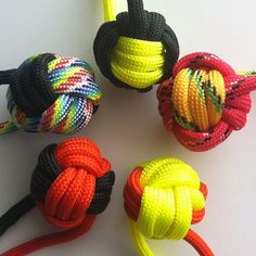 four different types of rope toys on a white surface with one knoted up and the other tied down