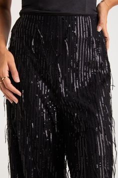 The most glamorous way to elevate any late-night look is with the Lulus Shimmery Aura Black Sequin Fringe High-Rise Wide-Leg Pants! Dazzling fringe-y sequin details adorn these mesh pants that feature a flattering high-rise fit and trendy wide pant legs that fall to full-length hems. Hidden side zipper/clasp. Pair with an equally shiny pair of heels for a truly stunning look! Fit: This garment fits true to size. Length: Ankle length. Size medium Inseam: 29.00 Front Rise: 12.50 Waist: Fitted - ve Fringe Pants, Mesh Pants, Sequin Pants, Lulu Fashion, High Rise Pants, Wide Pants, Night Looks, Black Sequins, Late Night