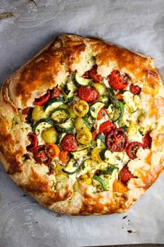 a pizza sitting on top of a pan covered in cheese and veggie toppings