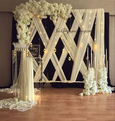 a wedding setup with white flowers and candles