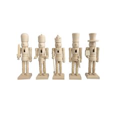 four wooden toy soldiers standing next to each other