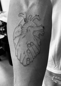 a black and white photo of a heart tattoo