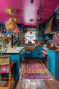 a kitchen with blue cabinets and colorful rugs on the floor in front of it