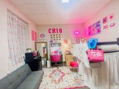 a room that has pink lights on the ceiling and furniture in front of it,