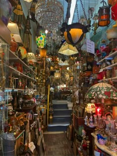 a store filled with lots of lamps and chandeliers