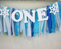 one banner hanging on the wall with snowflakes and streamers attached to it