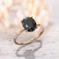 a black diamond ring sitting on top of a table