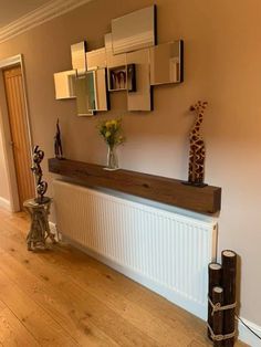 a vase with flowers and giraffes on the wall in front of a radiator