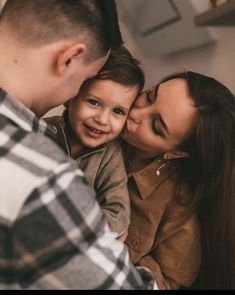 a man and woman holding a small child