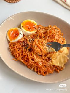 a plate with noodles and eggs on it