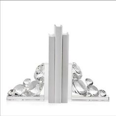 two white bookends with crystal stones on them