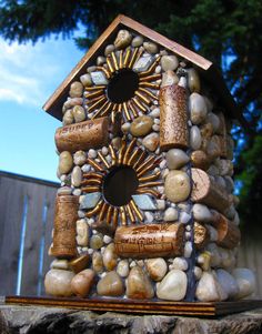 a bird house made out of rocks and wine corks