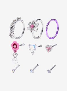 six pairs of piercings with flowers and hearts on each earring, all in different colors