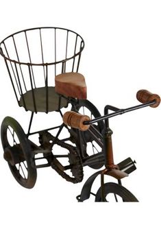 an old fashioned tricycle with a basket on the back