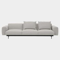 a gray couch sitting on top of a white floor