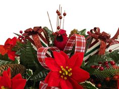 a christmas arrangement with poinsettis and candy canes