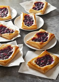 several pieces of pie on plates with napkins