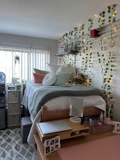 a bedroom with a bed, desk and computer on the table in front of it