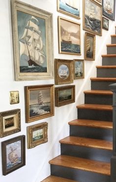 there is a staircase with pictures on the wall