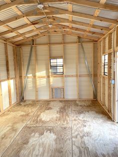 an empty room with wooden walls and flooring in the process of being renovated by someone