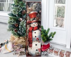 a snowman is standing next to a christmas tree